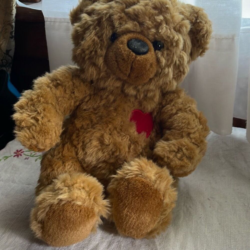 10” DGE plush curly haired Teddy bear with red heart.